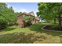Expansive backyard featuring lush green lawn and mature trees at 18305 Dembridge Dr, Davidson, NC 28036