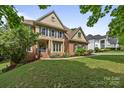 Elegant two-story home featuring a manicured lawn and beautiful landscaping at 18305 Dembridge Dr, Davidson, NC 28036