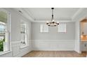 Dining room with natural light, wood flooring, and decorative molding at 2020 Embassy Ct # 48, Charlotte, NC 28213