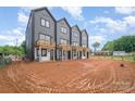A view of townhomes' backyards with wooden balconies offering outdoor relaxation in a shared outdoor space at 204 Mattoon St, Charlotte, NC 28216