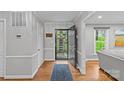 Light-filled entryway with hardwood floors, offering a glimpse of the beautifully landscaped exterior at 2418 Ainsdale Rd, Charlotte, NC 28226