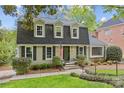 Charming home with neutral siding, black shutters, and a well-manicured front yard at 2418 Ainsdale Rd, Charlotte, NC 28226