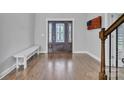 Inviting foyer featuring hardwood floors, a bench, and a decorative glass front door at 3075 Jamestown Dr, Gastonia, NC 28054