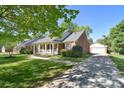 Beautiful brick home featuring a detached garage and well-kept lawn at 317 Port Royal Dr, Matthews, NC 28105