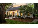 Inviting home exterior featuring manicured landscaping, stone steps, and a welcoming entrance at 3300 Sharon Rd, Charlotte, NC 28211
