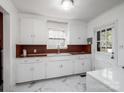 Bright kitchen with a farmhouse sink, white cabinets, and a window above sink at 412 Keels Ave, Rock Hill, SC 29730