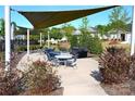 Relaxing community outdoor seating area with tables, chairs, grills and sunshade covering at 4171 Canopy Creek Dr, Denver, NC 28037