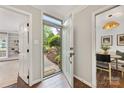 Inviting foyer with wood floors and a view of the landscaped front yard through the open front door at 4360 Woodglen Ln, Charlotte, NC 28226