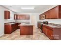Well-equipped kitchen with central island, stainless steel appliances, and ample cabinetry at 5030 Ashley Place Dr, Bessemer City, NC 28016