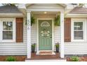 Welcoming front entrance featuring a green door, sidelight windows, and potted plants at 506 Englewood Ne St, Concord, NC 28025
