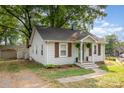 Charming home featuring white siding, a green front door, and a well-maintained lawn at 506 Englewood Ne St, Concord, NC 28025