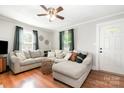 Inviting living room with a comfortable sectional sofa, wood floors, and natural light at 506 Englewood Ne St, Concord, NC 28025