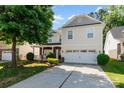Charming two-story home features a two-car garage, covered front porch, and mature landscaping at 5106 Stone Park Dr, Charlotte, NC 28269