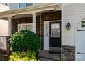 Inviting front entry featuring stone accents, a black front door, and manicured landscaping at 5106 Stone Park Dr, Charlotte, NC 28269