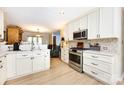 Modern kitchen features white cabinetry, stainless steel appliances, and ample countertop space at 5128 Dunes Ct, Charlotte, NC 28226