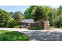 Cozy brick home featuring a bright red door, dark shutters, and accessible ramp access at 536 Hartness Rd, Statesville, NC 28677