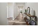 Long hallway featuring wood-look floors, white trim, and a console table at 536 Rustlewood Way, Rock Hill, SC 29732