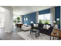 Open-concept living room featuring large windows, stylish furniture, and sleek flooring at 6165 Helens Rest Ln, Lincolnton, NC 28092