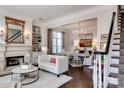 Bright living room featuring a fireplace, built-in shelving, and seamless access to the dining area at 6231 Wakehurst Rd, Charlotte, NC 28226