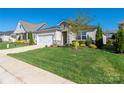 Well-maintained single-story home with lush green lawn, stone details, and an attached two-car garage at 6272 Raven Rock Dr, Denver, NC 28037
