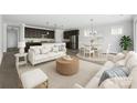 Bright and airy living room showcasing modern furnishings, open layout, and seamless flow to the kitchen at 6272 Raven Rock Dr, Denver, NC 28037