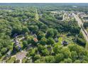 Aerial view of the property and neighborhood amidst lush green trees, offering a sense of community and location at 741 Bermuda Ave, Gastonia, NC 28054