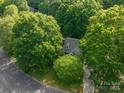 An aerial view of the home surrounded by lush green trees, showing its position in a tree-filled neighborhood at 741 Bermuda Ave, Gastonia, NC 28054