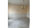 Spacious dining room featuring wainscoting and a classic chandelier fixture at 7505 Conifer Cir, Indian Trail, NC 28079