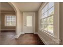 Bright entryway featuring hardwood floors, large windows, and decorative glass paneled front door at 8 Bolt Dr, Shelby, NC 28150