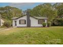 Charming single-story home with traditional architecture and mature trees in a green front yard at 8 Bolt Dr, Shelby, NC 28150