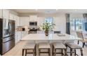 Modern kitchen with white cabinets, stainless steel appliances, a large island, and stylish seating at 103 White Apple Way, Statesville, NC 28625