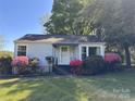 Inviting single-story home with a well-kept lawn, accented by colorful blooming azaleas at 1059 16Th Nw Ave, Hickory, NC 28601