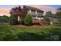Spacious backyard featuring a wooden deck and a lush green lawn at 10716 Persimmon Creek Dr, Mint Hill, NC 28227