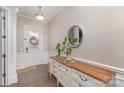 Entryway featuring a decorative door, hardwood floors, accent molding, a dresser, and a round mirror at 1210 Gold Rush Ct, Fort Mill, SC 29708