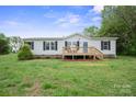 Inviting single-story home with a front deck and well-manicured lawn at 125 Rocky Pt, Cleveland, NC 27013
