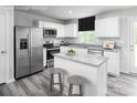 Bright kitchen featuring white cabinetry, stainless steel appliances, and granite countertops with a center island at 128 Millstream Dr, China Grove, NC 28023