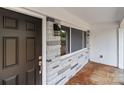 Welcoming front porch showcasing stone accents, a modern exterior light, and a glimpse of outdoor scenery at 1306 Klondale Ave, Kannapolis, NC 28081