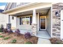 Cozy front porch showing stone pillars and a well-lit entrance with stylish front door and window at 1436 Ardmore Dr # 342, Sherrills Ford, NC 28673