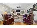 Spacious living room features hardwood floors, comfortable seating, a fireplace, and custom built-in shelving at 1467 Alexander Rd, Rock Hill, SC 29732