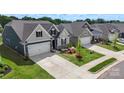 Aerial view showcasing new construction homes with landscaping and driveways on a sunny day at 167 White Apple Way, Statesville, NC 28625