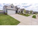 Street view of new construction homes with well-manicured lawns and sidewalks on a sunny day at 167 White Apple Way, Statesville, NC 28625