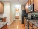 Efficient kitchen featuring stainless steel appliances, granite countertops, and hardwood floors at 208 Fielding St, Mount Holly, NC 28120