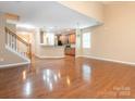 Open-concept living area featuring hardwood floors, plenty of natural light, and modern finishes at 208 Fielding St, Mount Holly, NC 28120