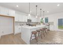 Modern eat-in kitchen with white cabinets, stainless steel appliances, and a large island with seating at 2309 Bulwarks Ct # 4P, Albemarle, NC 28001