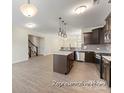 Open-concept kitchen featuring an island, stainless steel appliances, and seamless flow to the living spaces at 2309 Bulwarks Ct # 4P, Albemarle, NC 28001