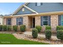 Inviting brick home exterior with well-manicured landscaping, featuring dark shutters and a welcoming entrance at 2322 Morrison Rd, York, SC 29745