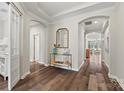 Elegant hallway featuring arched doorways, tray ceilings, hardwood floors, and decorative accents at 2322 Morrison Rd, York, SC 29745