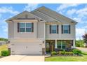 Charming two-story home with stone accents, a well-manicured lawn and a two-car garage at 2739 Golden Rose Ln, Charlotte, NC 28216