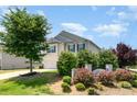 Beautifully landscaped yard with lush greenery, a charming two-story home, and a two-car garage at 2739 Golden Rose Ln, Charlotte, NC 28216
