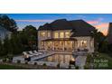 Luxurious backyard with pool, spa, fire pits, and covered patio, perfect for entertaining at 356 Yacht Rd, Mooresville, NC 28117